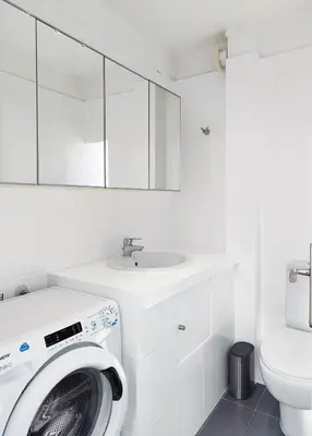 a white bathroom with a washing machine and a sink at KYMA Apartments - Athens Acropolis 15 in Athens
