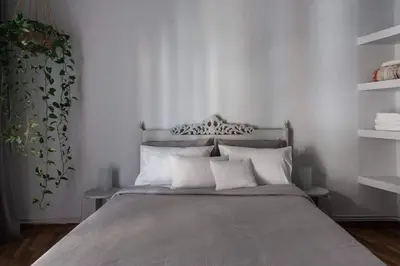 a bedroom with a large bed with white pillows at Cosy flat, perfectly located in historic centre! in Athens