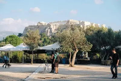a group of people walking their dogs in front of a mountain at Cosy flat, perfectly located in historic centre! in Athens