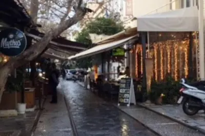 a city street with a building on a rainy day at Cosy flat, perfectly located in historic centre! in Athens