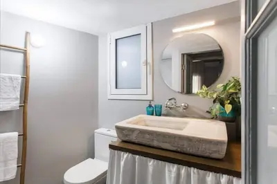 a bathroom with a sink and a toilet and a mirror at Cosy flat, perfectly located in historic centre! in Athens