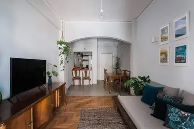 a living room with a couch and a flat screen tv at Cosy flat, perfectly located in historic centre! in Athens