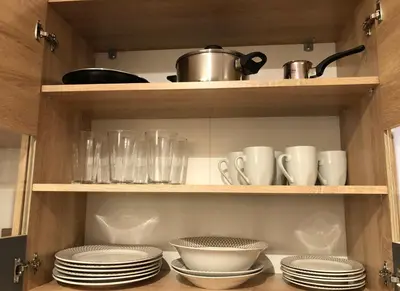 a cabinet filled with plates and cups and dishes at Lemon Tree Inn in Markopoulo