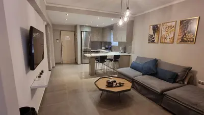 a living room with a couch and a table at Casa Moderno near the beach in Athens