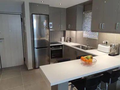 a kitchen with a bowl of fruit on a counter at Casa Moderno near the beach in Athens