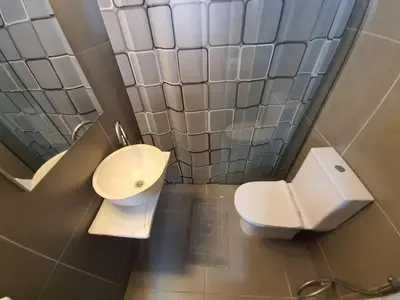a bathroom with a toilet and a sink at Casa Moderno near the beach in Athens