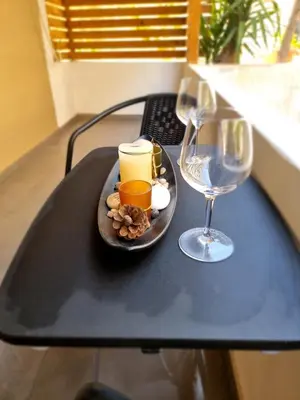 a plate of food and a wine glass on a table at Casa Moderno near the beach in Athens