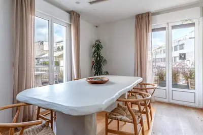 a dining room with a white table and chairs at LOFUS Bio-Suites in Athens