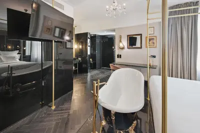 a bedroom with a white chair and a bed at Skylark, Aluma Hotels & Resorts in Athens