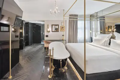 a bedroom with a white bed and a desk at Skylark, Aluma Hotels & Resorts in Athens
