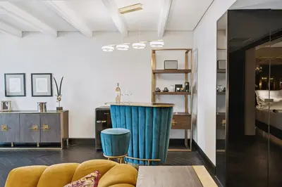 a living room with a yellow couch and a counter at Skylark, Aluma Hotels & Resorts in Athens