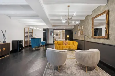 a living room with a yellow couch and chairs at Skylark, Aluma Hotels & Resorts in Athens