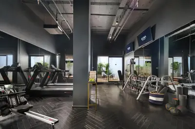 a gym with treadmills and machines in a room at Skylark, Aluma Hotels & Resorts in Athens