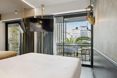 a hotel room with a bed and a balcony at Skylark, Aluma Hotels & Resorts in Athens