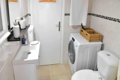 a white bathroom with a toilet and a sink at Glyfada's House Project! in Athens