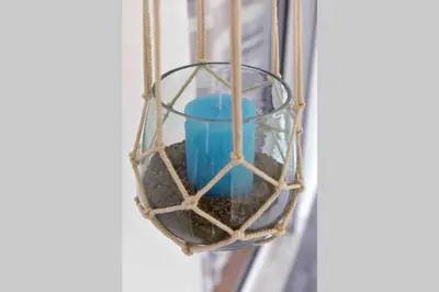 a blue candle in a hanging bird feeder at Glyfada's House Project! in Athens