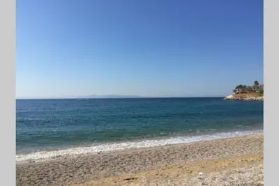 a beach with the ocean in the background at Glyfada's House Project! in Athens