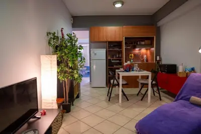 a living room with a couch and a table and a kitchen at 