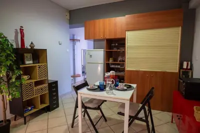 a kitchen with a white table and a refrigerator at 