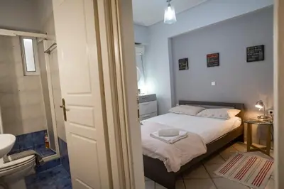 a small bedroom with a bed and a bathroom at 