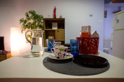 a table with a plate and a cup and a pitcher at 