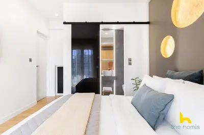 a bedroom with a white bed in a room at Urban Views, Modern Apartment In The Heart of Athens in Athens
