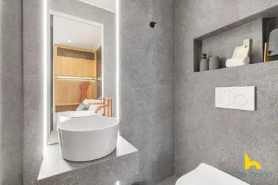 a bathroom with a tub and a sink and a mirror at Urban Views, Modern Apartment In The Heart of Athens in Athens