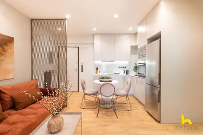 a kitchen and living room with a couch and a table at Urban Views, Modern Apartment In The Heart of Athens in Athens