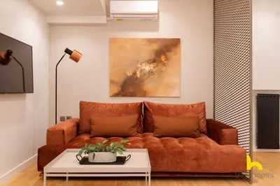 a living room with a couch and a table at Urban Views, Modern Apartment In The Heart of Athens in Athens