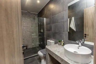 a bathroom with a sink and a shower at Raise Athens Metro Apartments in Athens
