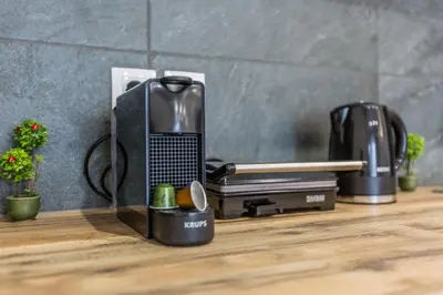 a kitchen counter with a laptop and a coffee maker at Raise Athens Metro Apartments in Athens