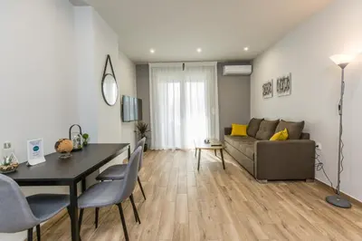 a living room with a table and a couch at Raise Athens Metro Apartments in Athens