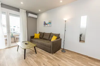 a living room with a couch and a table at Raise Athens Metro Apartments in Athens