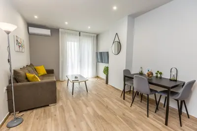 a living room with a table and a dining room at Raise Athens Metro Apartments in Athens