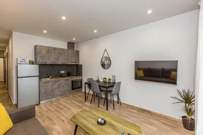 a kitchen and living room with a table and chairs at Raise Athens Metro Apartments in Athens