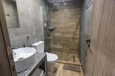 a bathroom with a white sink and a toilet at Raise Athens Metro Apartments in Athens