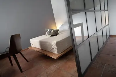 a bedroom with a bed and a mirror at Twin Circle Athens in Athens
