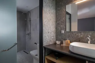 a bathroom with a sink and a toilet and a mirror at Twin Circle Athens in Athens