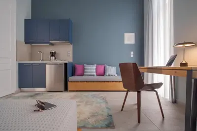 a kitchen and a living room with a couch at Twin Circle Athens in Athens