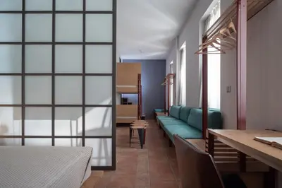 a room with a table and a blue couch at Twin Circle Athens in Athens