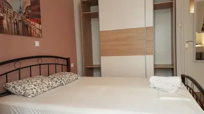 a bedroom with a bed with a pillow on it at Petrol Apartment- Athens Center, 4 BD, 1 BATH in Athens