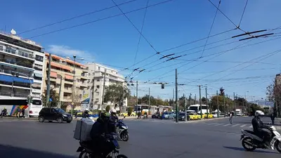 a group of people riding motorcycles down a city street at Petrol Apartment- Athens Center, 4 BD, 1 BATH in Athens