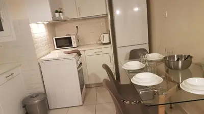 a small kitchen with a table and a microwave at Petrol Apartment- Athens Center, 4 BD, 1 BATH in Athens