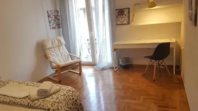 a room with a bed and a desk and a chair at Petrol Apartment- Athens Center, 4 BD, 1 BATH in Athens