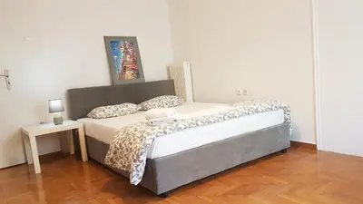a bed in a white room with a bed sidx sidx sidx at Petrol Apartment- Athens Center, 4 BD, 1 BATH in Athens