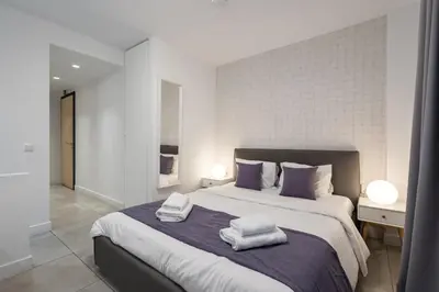 a bedroom with a large bed with towels on it at Trikoupi 95 in Athens
