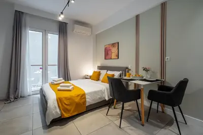 a bedroom with a bed and a table and chairs at Trikoupi 95 in Athens