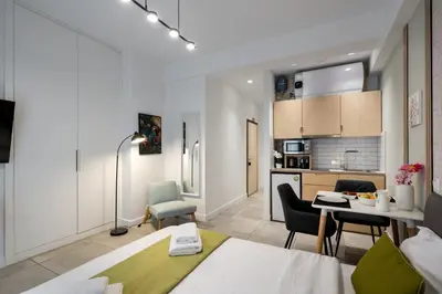 a kitchen and living room with a table and chairs at Trikoupi 95 in Athens