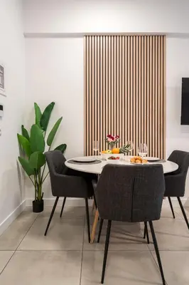 a dining room with a white table and chairs at Trikoupi 95 in Athens
