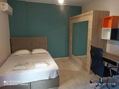 a bedroom with a bed and a table and a desk at Παιδων στουντιο 3 in Athens